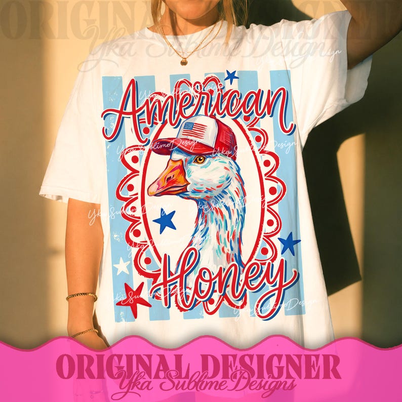May include: White t-shirt featuring a goose wearing a red, white, and blue hat. The shirt has the words "American Honey" in a script font, with stars and stripes design elements. The design is centered on the shirt.