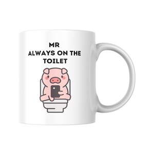 May include: White ceramic mug with a handle. The mug features the text "MR ALWAYS ON THE TOILET" above a cartoon pig sitting on a toilet, holding a smartphone.