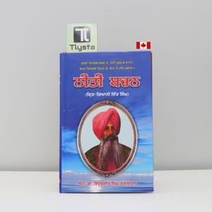 May include: A hardcover book titled "Neeti Bachan" in Punjabi. The cover is predominantly blue, featuring an oval portrait of a man with a red turban and long beard. The book also has text in Punjabi.