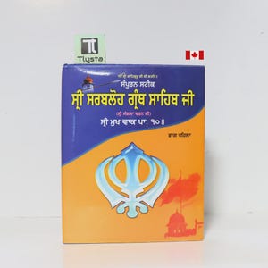 May include: A book with a blue and orange cover featuring text in a foreign language. The cover has a large emblem in the center and a red flag with a building illustration. The book is titled "Sri Sarbloh Granth Sahib Ji."