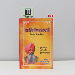 May include: A book with a vibrant orange cover featuring text in a foreign language and a portrait of a man with a pink turban and long white beard. The book has a Canadian flag and the Tlysta logo.