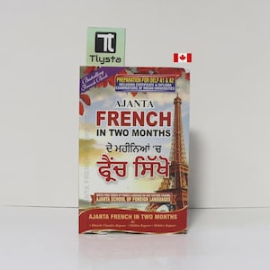 May include: A book titled "AJANTA FRENCH IN TWO MONTHS" with the Eiffel Tower on the cover. The book is for preparation for DELF A1 & A2 exams. The book also has text in a different language. A green and white logo is in the top left corner.