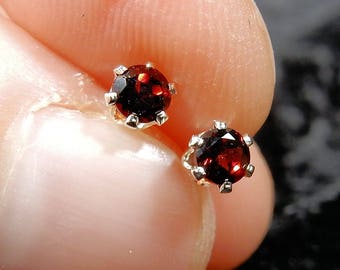 Tiny red garnets in sterling silver earring stud posts (the birthstone for January)