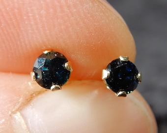 Tiny dark blue sapphire ear studs or posts in 14 kt gold - the birthstone for September