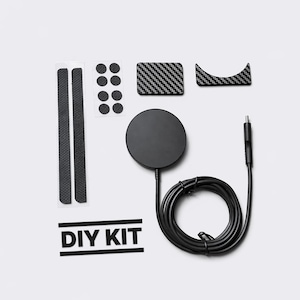 May include: A black DIY kit with various components, including a round charging pad, carbon fiber-style accents, and a coiled cable. The kit also includes adhesive strips and the text "DIY KIT".