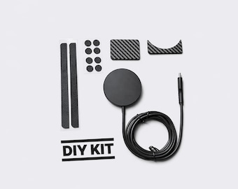 May include: A black DIY kit with various components, including a round charging pad, carbon fiber-style accents, and a coiled cable. The kit also includes adhesive strips and the text "DIY KIT".