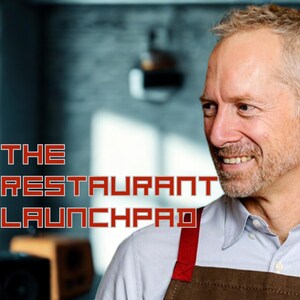 May include: A man in a brown apron with red straps smiles. The red text reads "THE RESTAURANT LAUNCHPAD". The background is blurred, with a focus on the man and the text. The image suggests a restaurant or food-related theme.