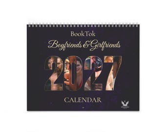 May include: A spiral-bound 2027 wall calendar with a dark purple starry background. The cover features the text BookTok Boyfrends & Girlfriends and the year 2027, with photographic portraits of people integrated into the large numbers.