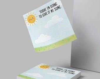 May include: A stack of square sticky notes with a cheerful design. The notes feature a smiling sun, clouds, and a grassy field against a light blue sky. Text on the notes reads, "TODAY, I'M GOING TO GIVE IT MY SOME."