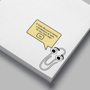 May include: A stack of white sticky notes with a cartoon paperclip character. The paperclip has googly eyes and a speech bubble that reads, "It looks like you're having a breakdown at work. Do you need help? Yes."