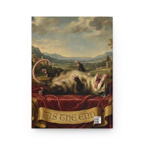May include: A notebook featuring a classical painting of an opossum lying on its back with its mouth open. The opossum is on a red velvet cloth with a banner that reads "Tis the end". The background shows a landscape with mountains and buildings.