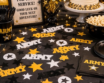 May include: A table decorated for a celebration with an "Army" theme. Features a cake, popcorn, and a sign saying "Thank You For Your Service! Good Luck On Your Next Adventure!" Black, gold, and white star-shaped confetti and decorations.