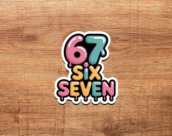 May include: A colorful sticker with the number "67" and the words "Six Seven" in a playful font. The numbers are pink and teal, and the words are yellow and pink, all outlined in white.