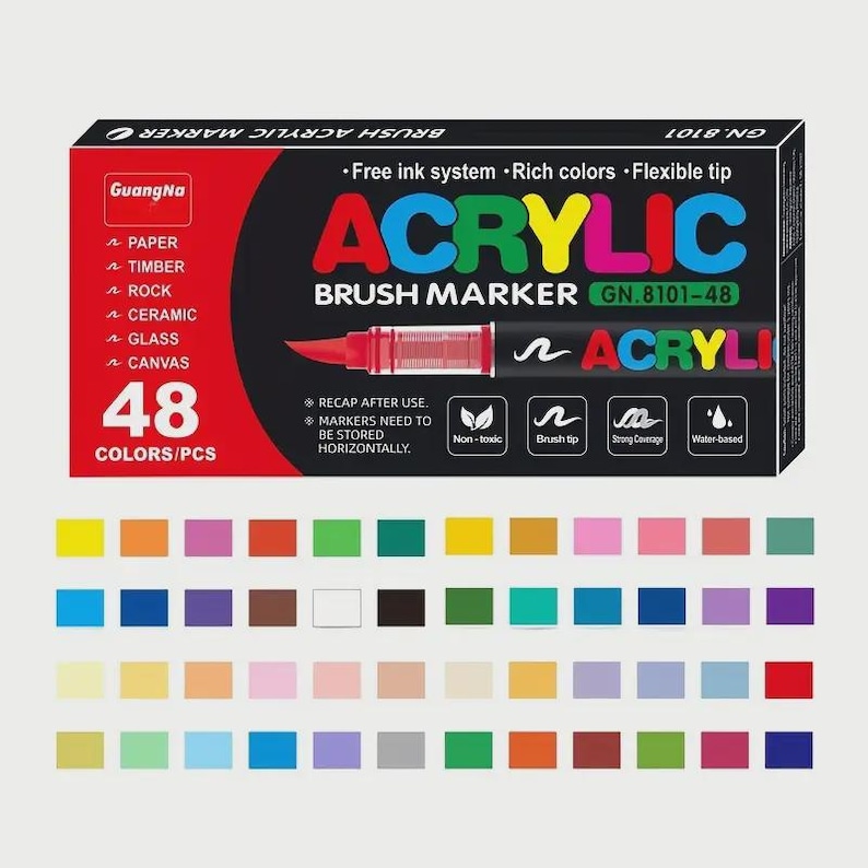 May include: A set of 48 acrylic brush markers in various colors, displayed below a black and red box. The box features the text "ACRYLIC BRUSH MARKER" and "GN.8101-48". The markers are water-based and non-toxic.