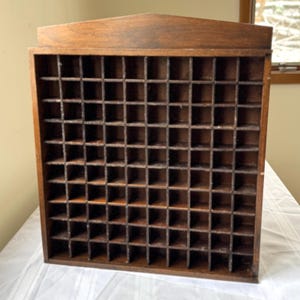 Dedal antiguo de madera con forma de casa, objeto decorativo.