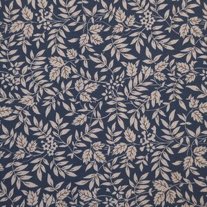 May include: A dark navy blue fabric featuring a repeating pattern of light beige leaves, small branches, and clusters of tiny flowers. The design is dense and intricate, covering the entire surface with a consistent botanical motif throughout.