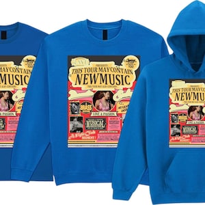 May include: Three blue shirts: a t-shirt, a sweatshirt, and a hooded sweatshirt. Each features a graphic with the text "THIS TOUR MAY CONTAIN NEW MUSIC" and images of performers. The graphic is in shades of red, yellow, and black.