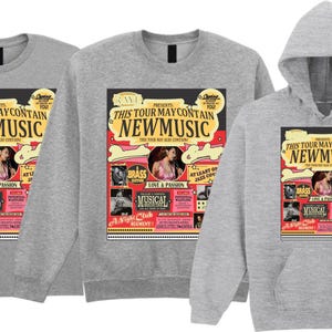 May include: Three light gray shirts: a t-shirt, a sweatshirt, and a hooded sweatshirt. Each features a colorful graphic with the text "THIS TOUR MAY CONTAIN NEW MUSIC" and images of a woman, musical notes, and the word "MUSICAL".