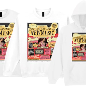 May include: White t-shirts, a sweatshirt, and a hoodie featuring a colorful graphic. The graphic reads "THIS TOUR MAY CONTAIN NEW MUSIC" with images of a woman, the word "BRASS", and "MUSICAL".