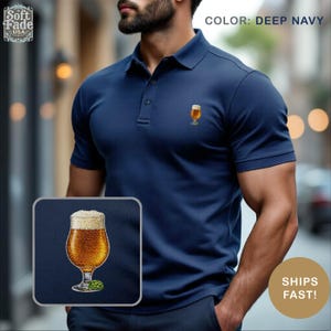 May include: Deep navy blue polo shirt with a small embroidered beer glass design. The shirt has short sleeves and a classic collar. The text "COLOR: DEEP NAVY" is visible in the image.