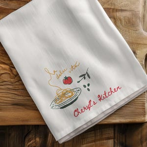 Luxury kitchen towel hanging from brass oven handle inside elegant neutral farmhouse interior, personalized linen cloth, hostess appreciation present, wedding registry accessory, bridal shower favorite, cottagecore decoration, gourmet cooking accent, holiday entertaining essential, grandmother keepsake, rustic culinary styling, minimal aesthetic textile, housewarming surprise, baker companion, chef inspired fabric, decorative drying cloth, upscale apartment decor, cream cotton material