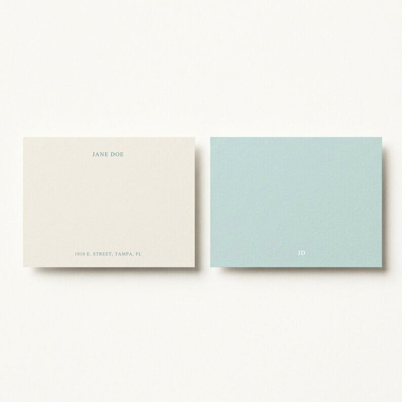 Soft blue and ivory personalized stationery duo displayed in a clean editorial flat lay, elegant custom correspondence set for bridal shower thank you notes, baby shower cards, thoughtful hostess gift, feminine desk accessories, chic writing paper set, modern social stationery, custom monogram note cards, luxury gift for newlyweds, pastel office decor aesthetic, refined paper goods for everyday notes, stylish personalized paper set for women and professionals