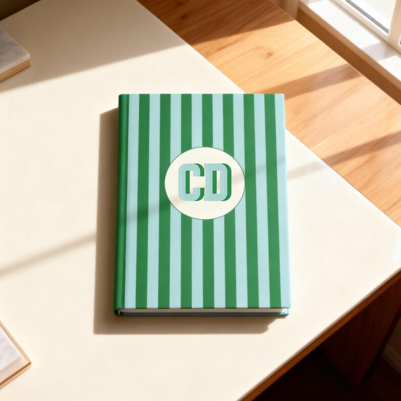 Green and light blue striped personalized notebook featuring custom initials on the front cover. Monogrammed hardcover journal with lined perforated pages for writing, planning, or work notes. Perfect aesthetic stationery gift for professionals, students, or teachers. Custom name notebook ideal for office, school, or journaling. Elegant personalized green stripe notebook for business meetings, organization, or daily reflections.