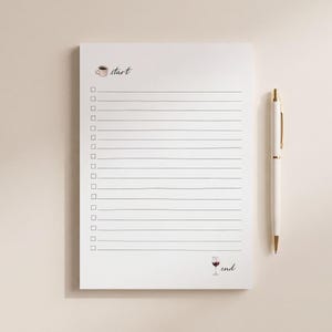 May include: A white notepad with horizontal lines and a column of checkboxes. The top left features a small coffee cup icon with the word start, and the bottom right shows a wine glass icon with the word end. A white pen with gold accents is placed beside it.
