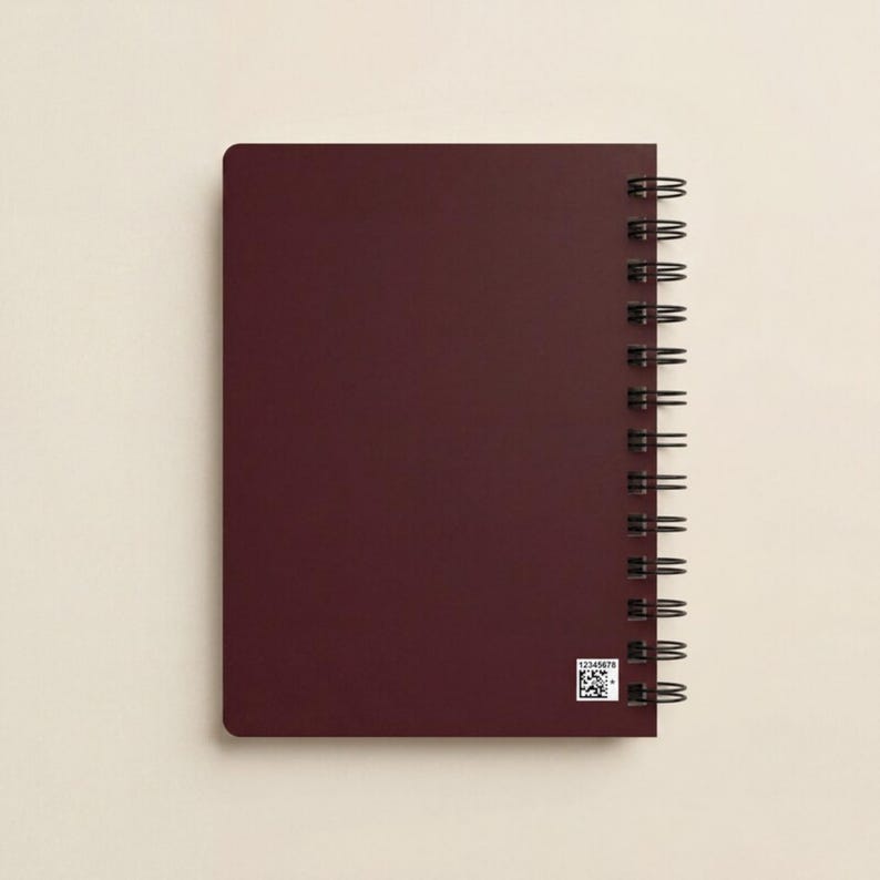 Blush pink spiral notebook featuring elegant white logo design displayed on a modern workspace desk with plant decor. Ideal for personalized business stationery, feminine branding, or executive office planners. Perfect for client gifts, event branding, and team journals. Aesthetic spiral notebook for creative professionals, business owners, and entrepreneurs who value modern, custom design office supplies.
