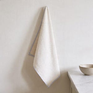 Blank kitchen tea towel back side mockup, neutral farmhouse hand towel, custom linen towel display, personalized housewarming gift idea, minimalist kitchen decor, elegant hostess present, realtor closing gift, Airbnb styling essential, bridal shower favor option, apartment warming present, modern countertop accent, soft luxury home textile, everyday cooking accessory, neutral home staging prop, refined kitchen linen, gift for bakers, interior styling accessory, premium towel mockup.