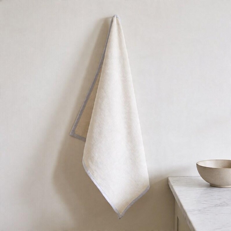 Blank kitchen tea towel back side mockup, neutral farmhouse hand towel, custom linen towel display, personalized housewarming gift idea, minimalist kitchen decor, elegant hostess present, realtor closing gift, Airbnb styling essential, bridal shower favor option, apartment warming present, modern countertop accent, soft luxury home textile, everyday cooking accessory, neutral home staging prop, refined kitchen linen, gift for bakers, interior styling accessory, premium towel mockup.