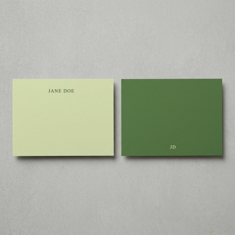 Personalized sage green flat note cards with matching envelopes shown in a minimalist neutral flat lay, elegant custom stationery set featuring modern correspondence cards, monogram writing paper, thank you note set, premium personalized paper goods, wedding stationery gift, luxury boxed note cards, aesthetic office desk stationery, custom folded cards with envelopes, sophisticated everyday correspondence set, muted green stationery gift for women, refined paper product mockup for Etsy listing