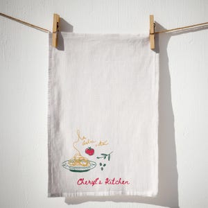 Luxury kitchen towel hanging in sunlit neutral interior, floral personalized tea cloth, farmhouse inspired decor, gourmet cooking textile, elegant homemaking accessory, bridal shower gift, hostess appreciation favorite, cozy apartment styling, cotton drying cloth, sophisticated kitchen furnishing, decorative linen accent, chic culinary detail, premium household essential, baking companion, timeless countertop decor, neutral aesthetic, modern domestic accessory, cottage inspired textile