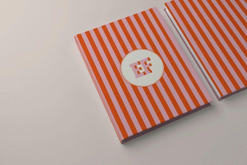 Orange and pink striped personalized notebooks with monogram initials on the front covers. Custom hardcover journals with perforated lined pages for writing or journaling. Modern stationery design perfect for students, professionals, or office use. Aesthetic orange stripe notebook gift for coworkers or friends who love personalized paper goods and elegant writing journals.