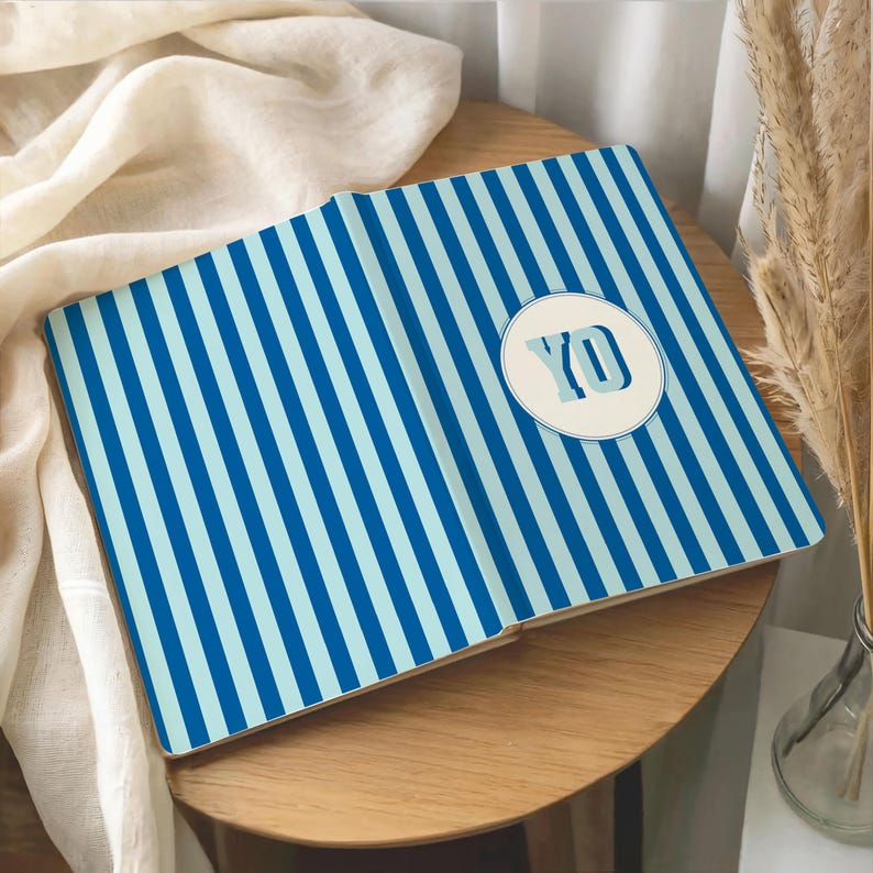 Blue and light blue striped personalized notebook featuring custom initials on the front. Elegant monogrammed journal with perforated lined pages for writing, journaling, or professional notes. Aesthetic hardcover notebook for office, school, or personal use. Custom name stationery gift for students, coworkers, or loved ones. Stylish blue stripe personalized notebook ideal for daily planning, business meetings, or journaling inspiration.