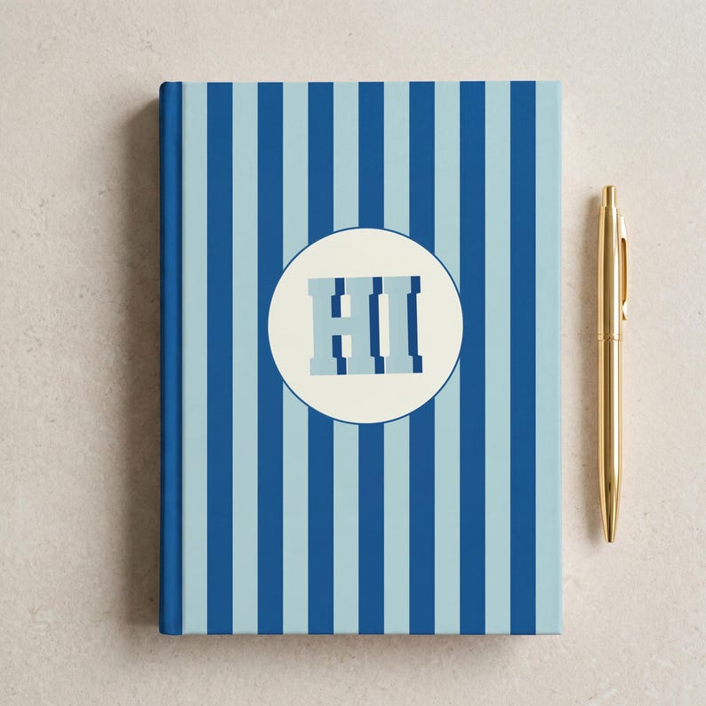 Blue and light blue striped personalized notebook with monogrammed initials on the cover beside a decorative branch. Elegant hardcover journal with perforated lined pages for daily writing, school, or office notes. Aesthetic blue stripe design perfect for journaling, business planning, or gift-giving. Custom name notebook ideal for professionals, students, and lovers of unique stationery.