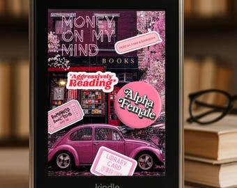 May include: A Kindle e-reader displays a pink graphic with the text "Money on My Mind" and "Books." The graphic includes a pink car, stickers, and the words "Alpha Female" and "Library Card."