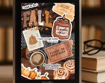 May include: Kindle e-reader with fall-themed stickers. The stickers include pumpkins, coffee, cinnamon rolls, and the words "Fall Vibes" and "Pumpkin Spice." The screen displays the word "kindle" at the bottom.