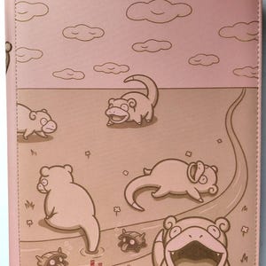 Könnte beinhalten: Rosa Kartenordner mit Cartoon-Illustrationen von Slowpoke-Charakteren. Das Design zeigt einen Himmel mit Wolken und einen Boden mit Slowpoke, einen gewundenen Pfad und das "vaultx"-Logo.