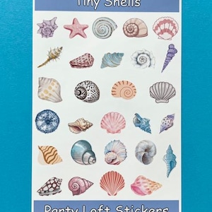 May include: A sheet of stickers featuring various seashell illustrations in shades of pink, blue, tan, and white. The text "Tiny Shells" and "Party Loft Stickers" are printed on the sheet.