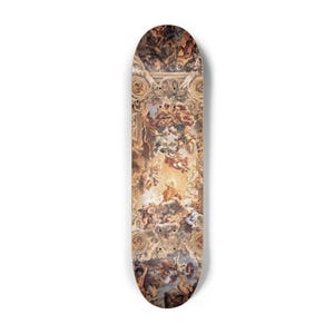 May include: A skateboard deck featuring a detailed Renaissance-style painting with figures, clouds, and architectural elements in shades of brown, beige, and gold. The deck has a standard shape and is designed for skateboarding.
