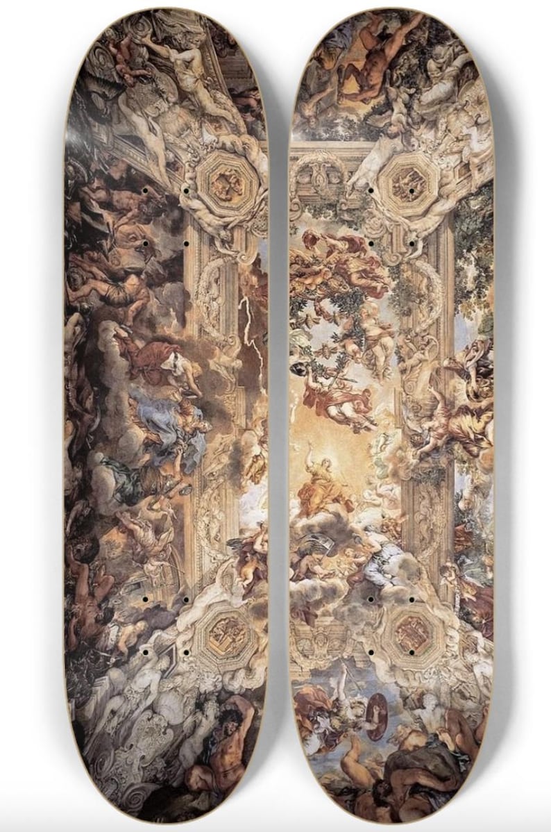May include: Two skateboards with a classical painting design. The artwork depicts a detailed scene with figures, clouds, and architectural elements in shades of brown, beige, and blue. The boards have a curved shape and a light-colored wood base.