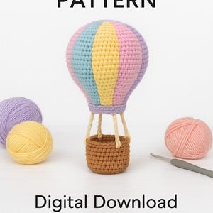 May include: A colorful crochet hot air balloon with a brown basket, pastel pink, blue, and yellow sections, and cream-colored ropes. The text "PDF Crochet Pattern" and "Digital Download" are displayed.
