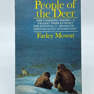 May include: A vintage paperback book titled People of the Deer by Farley Mowat. The blue cover features an illustration of two figures in dark winter clothing in a snowy landscape with a deer in the distance. Text includes Pyramid N1821 95 cents.