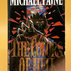 May include: Book cover for "The Colors of Hell" by Michael Paine. The cover features a dark, ominous illustration with a monster and clawed hand. Text includes the title, author's name, and the phrase "A Shattering Novel of Unholy Terror."