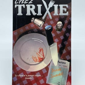 May include: A book titled Chez Trixie with a cover illustration of a plate with red stains, a knife, salt and pepper shakers, and a restaurant bill. The text reads Frissons, Chez Trixie, Facture, Bonne Journée, and Le client n'a jamais raison... Jamais!