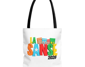 May include: White tote bag with black handles featuring the text "LA SANSE 2026" in colorful 3D letters. The design includes a star and building illustrations, creating a vibrant and eye-catching graphic.