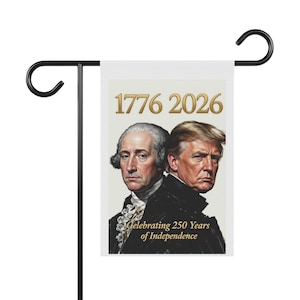 May include: A white garden flag featuring portraits of George Washington and Donald Trump, with the dates "1776 2026" in gold. The text "Celebrating 250 Years of Independence" is below the portraits. The flag is mounted on a black metal stand.
