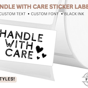 May include: White sticker labels with the text "HANDLE WITH CARE" in black, accompanied by heart graphics. The labels are part of a roll, with the text "CUSTOM TEXT", "CUSTOM FONT", and "BLACK INK" displayed. The words "8 STYLES!" are also visible.