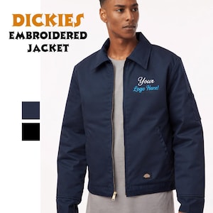May include: Navy blue embroidered jacket with the text "DICKIES EMBROIDERED JACKET". The jacket has a zipper closure, a collar, and a small pocket on the sleeve. The text "Your Logo Here!" is embroidered on the chest.